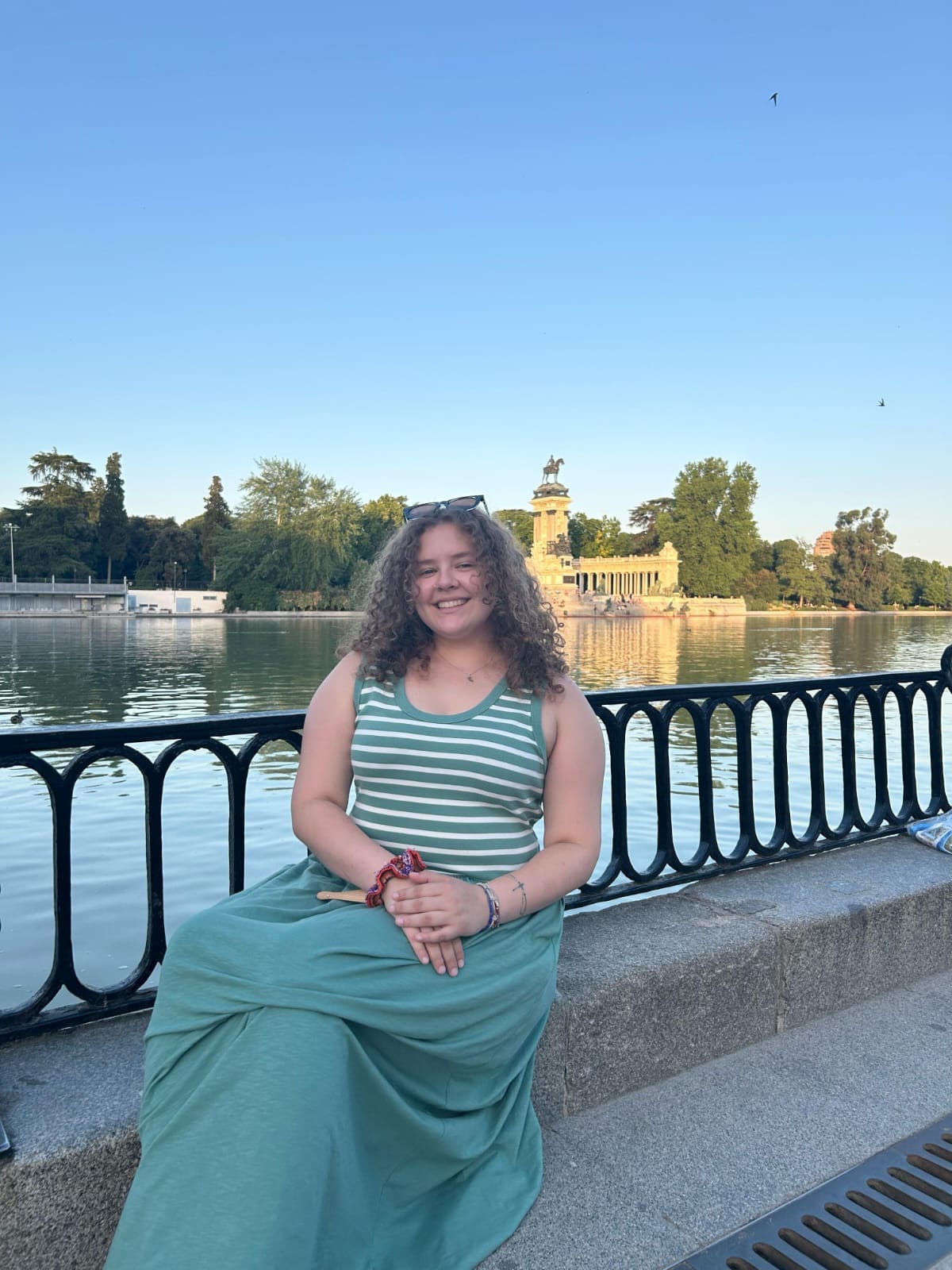 Nia smiling by a lake
